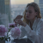 Sad woman sitting near window