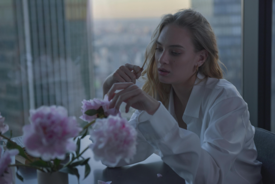 Sad woman sitting near window