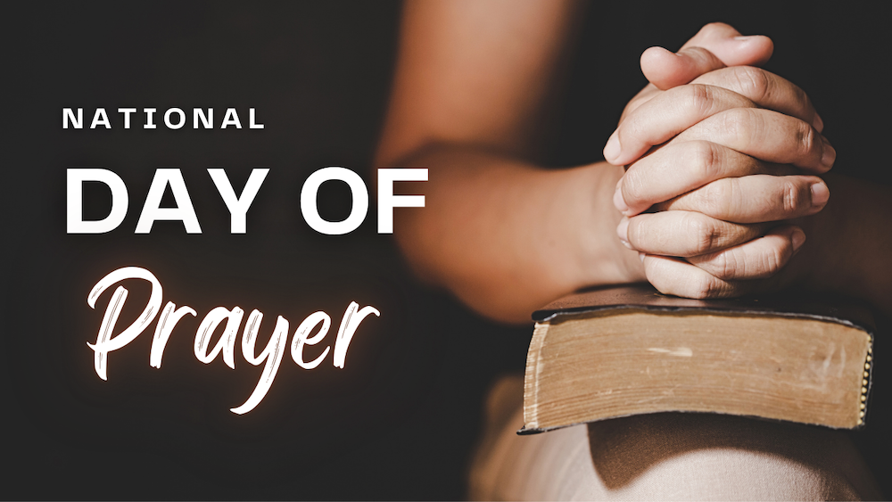 National Day Of Prayer - person folding hands on Bible copy