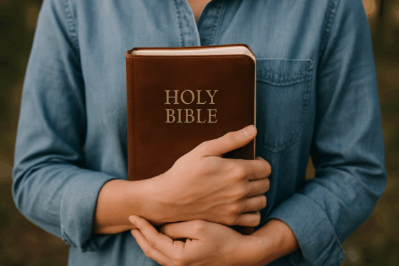 Woman holding a Bible close to her heart